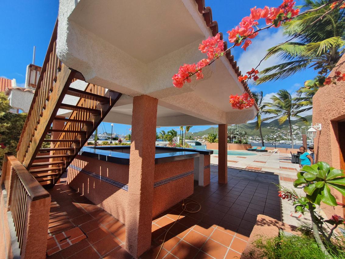 Luxury home for sale St Maarten in prestigious Simpson Bay Yacht Club. Tennis court. 24/7 security