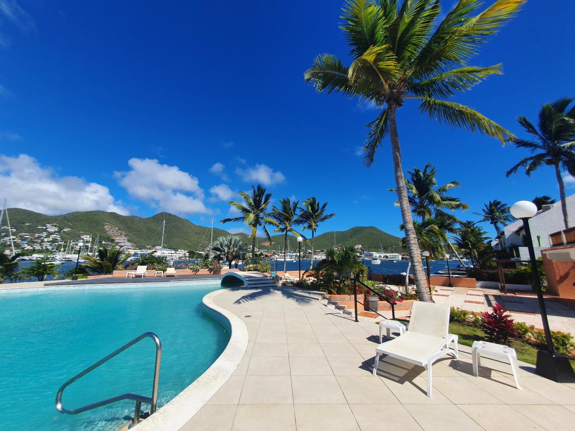 Luxury home for sale St Maarten in prestigious Simpson Bay Yacht Club. Tennis court. 24/7 security