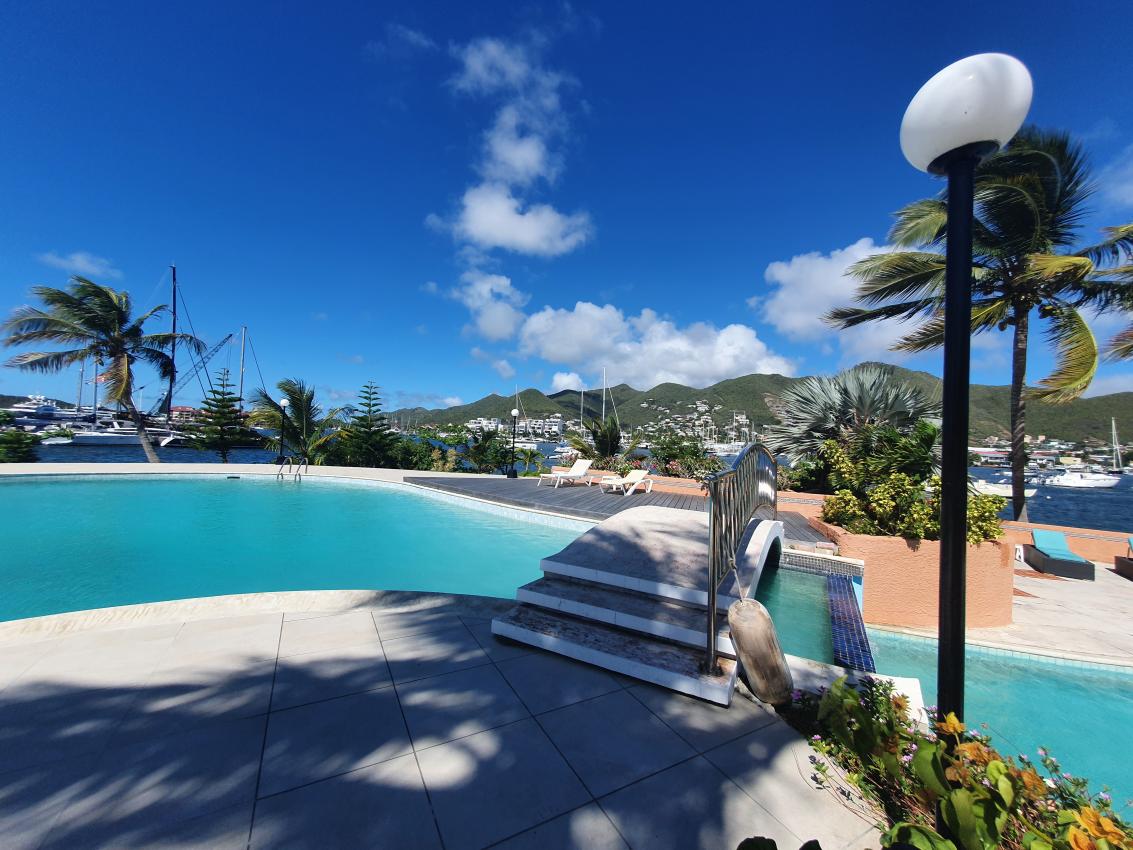 Luxury home for sale St Maarten in prestigious Simpson Bay Yacht Club. Tennis court. 24/7 security