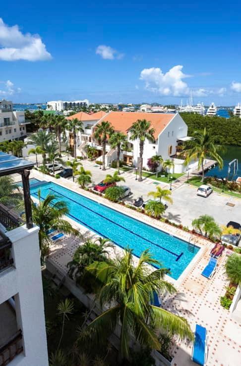 Luxury home for sale St Maarten in prestigious Simpson Bay Yacht Club. Tennis court. 24/7 security