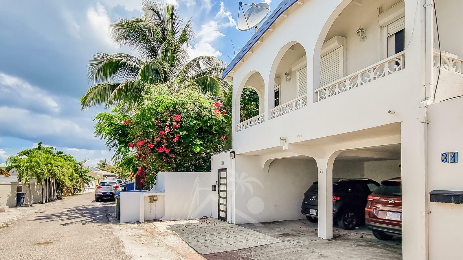 Waterfront Caribbean Villa for sale St Maarten, Beacon Hill. 2 bedrooms + Studio. Beach view. Boats