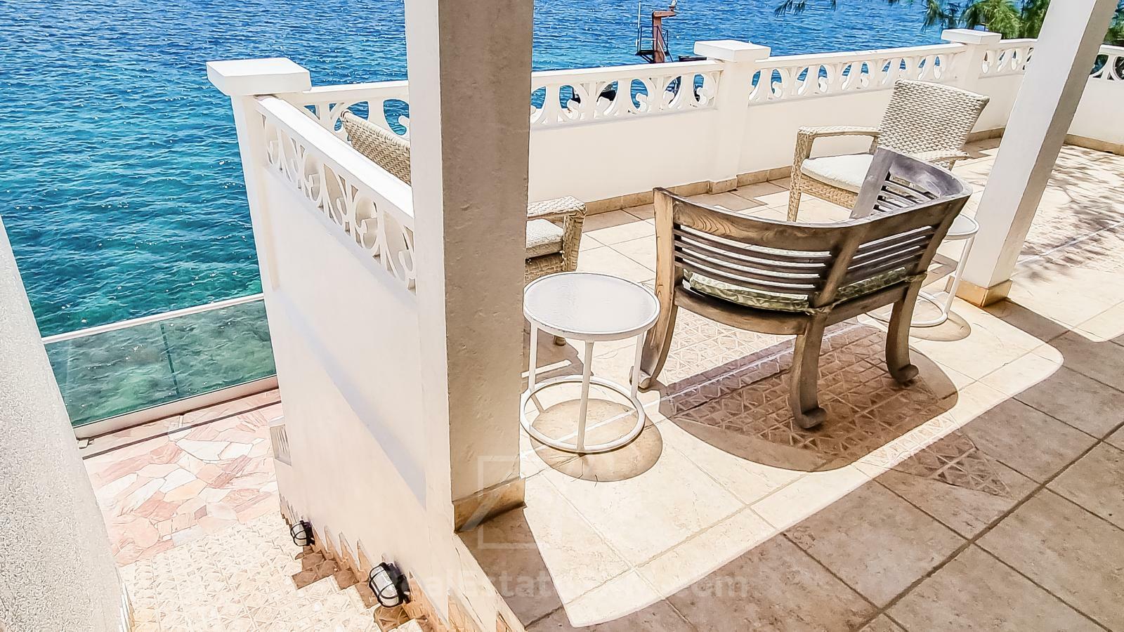 Waterfront Caribbean Villa for sale St Maarten, Beacon Hill. 2 bedrooms + Studio. Beach view. Boats