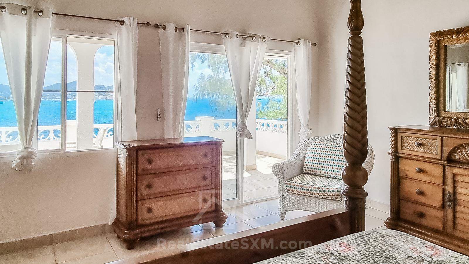 Waterfront Caribbean Villa for sale St Maarten, Beacon Hill. 2 bedrooms + Studio. Beach view. Boats