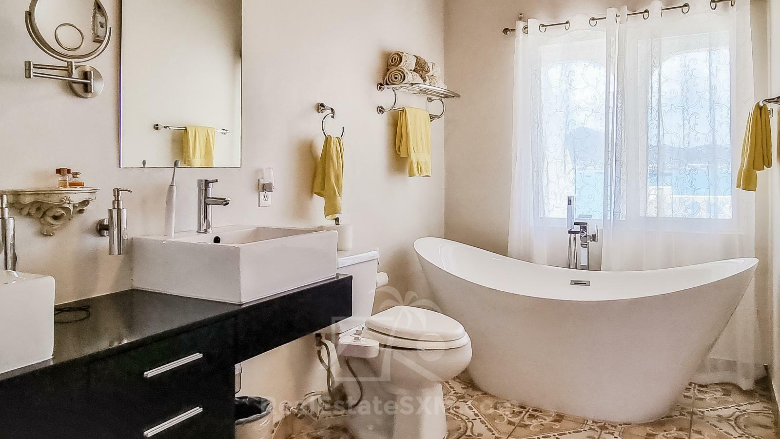 Waterfront Caribbean Villa for sale St Maarten, Beacon Hill. 2 bedrooms + Studio. Beach view. Boats