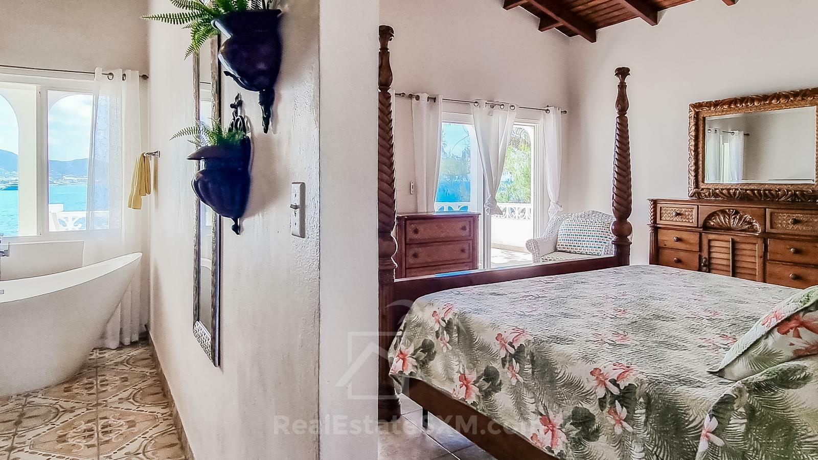 Waterfront Caribbean Villa for sale St Maarten, Beacon Hill. 2 bedrooms + Studio. Beach view. Boats
