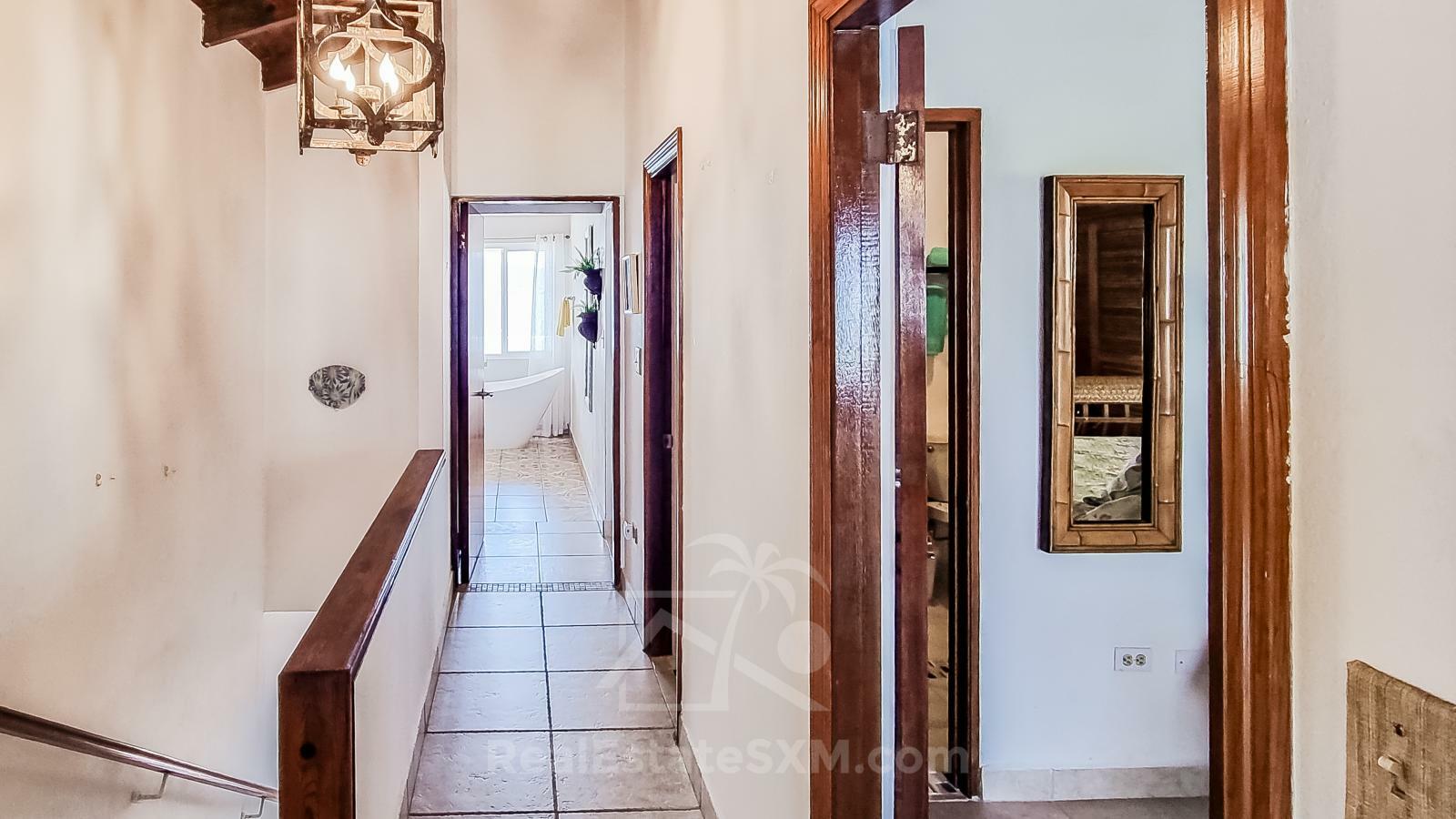 Waterfront Caribbean Villa for sale St Maarten, Beacon Hill. 2 bedrooms + Studio. Beach view. Boats