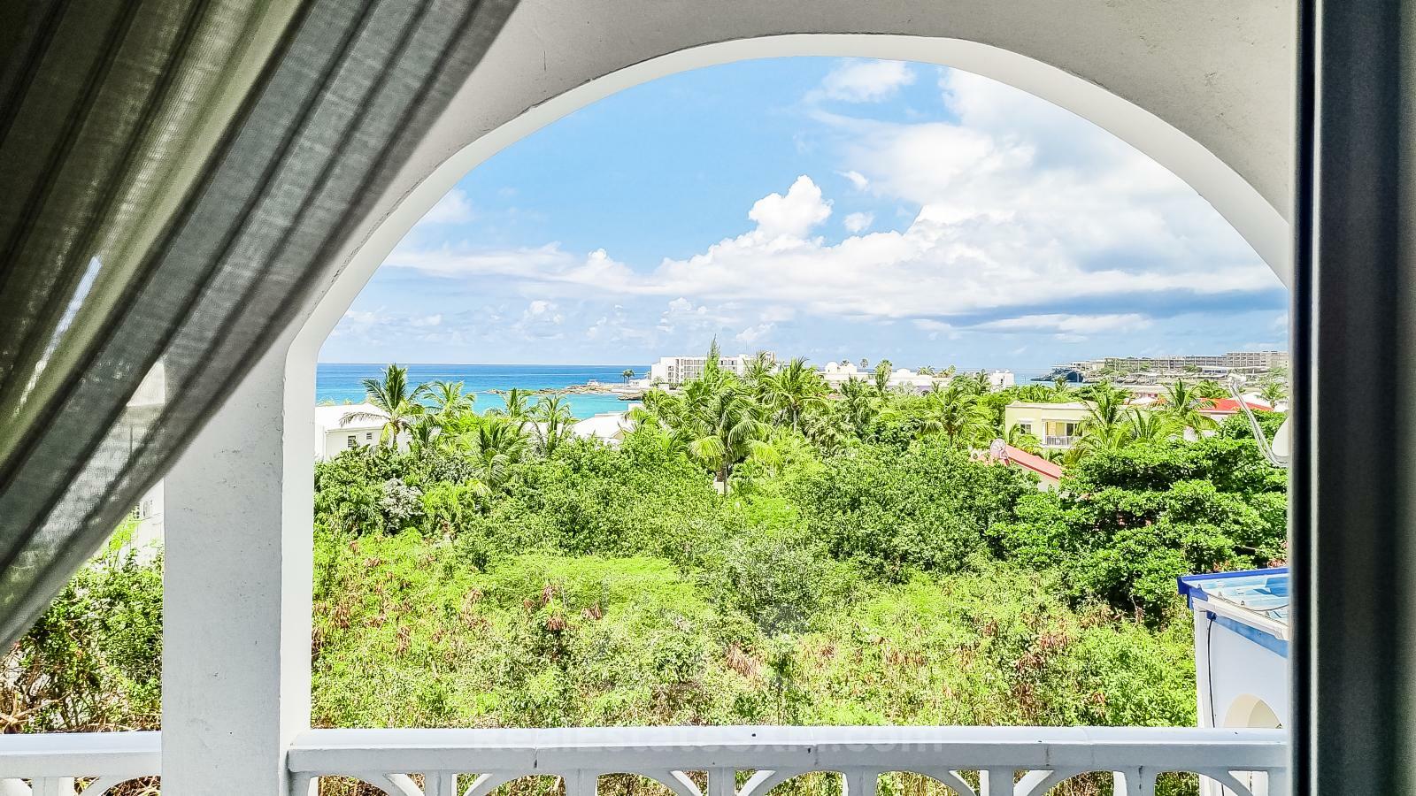 Waterfront Caribbean Villa for sale St Maarten, Beacon Hill. 2 bedrooms + Studio. Beach view. Boats