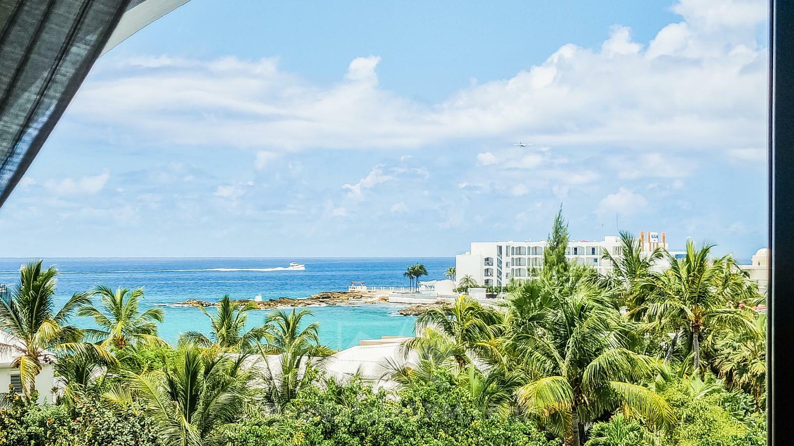 Waterfront Caribbean Villa for sale St Maarten, Beacon Hill. 2 bedrooms + Studio. Beach view. Boats