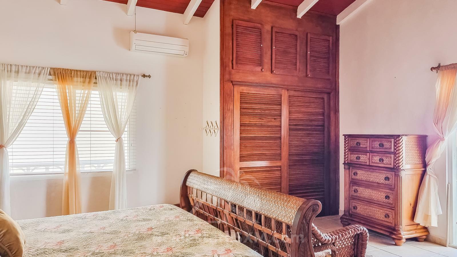 Waterfront Caribbean Villa for sale St Maarten, Beacon Hill. 2 bedrooms + Studio. Beach view. Boats