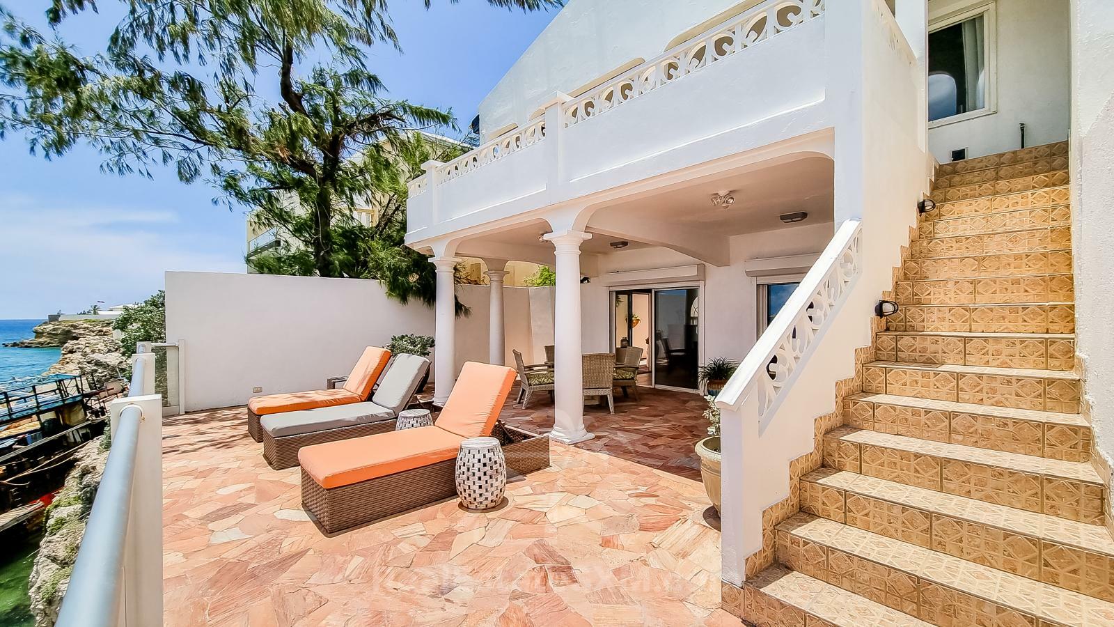 Waterfront Caribbean Villa for sale St Maarten, Beacon Hill. 2 bedrooms + Studio. Beach view. Boats