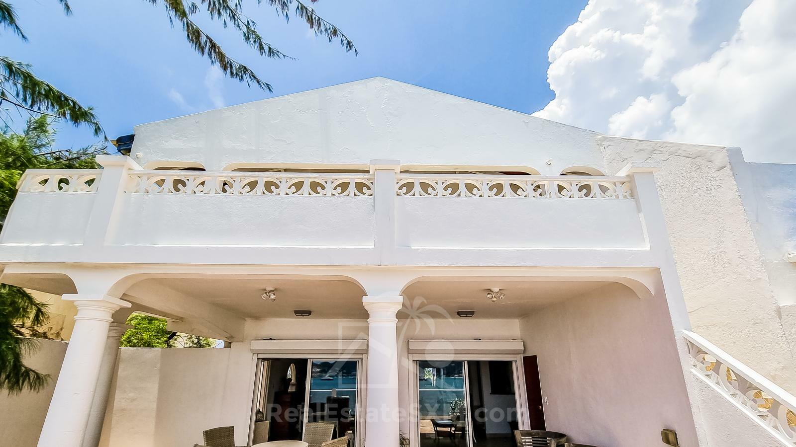 Waterfront Caribbean Villa for sale St Maarten, Beacon Hill. 2 bedrooms + Studio. Beach view. Boats