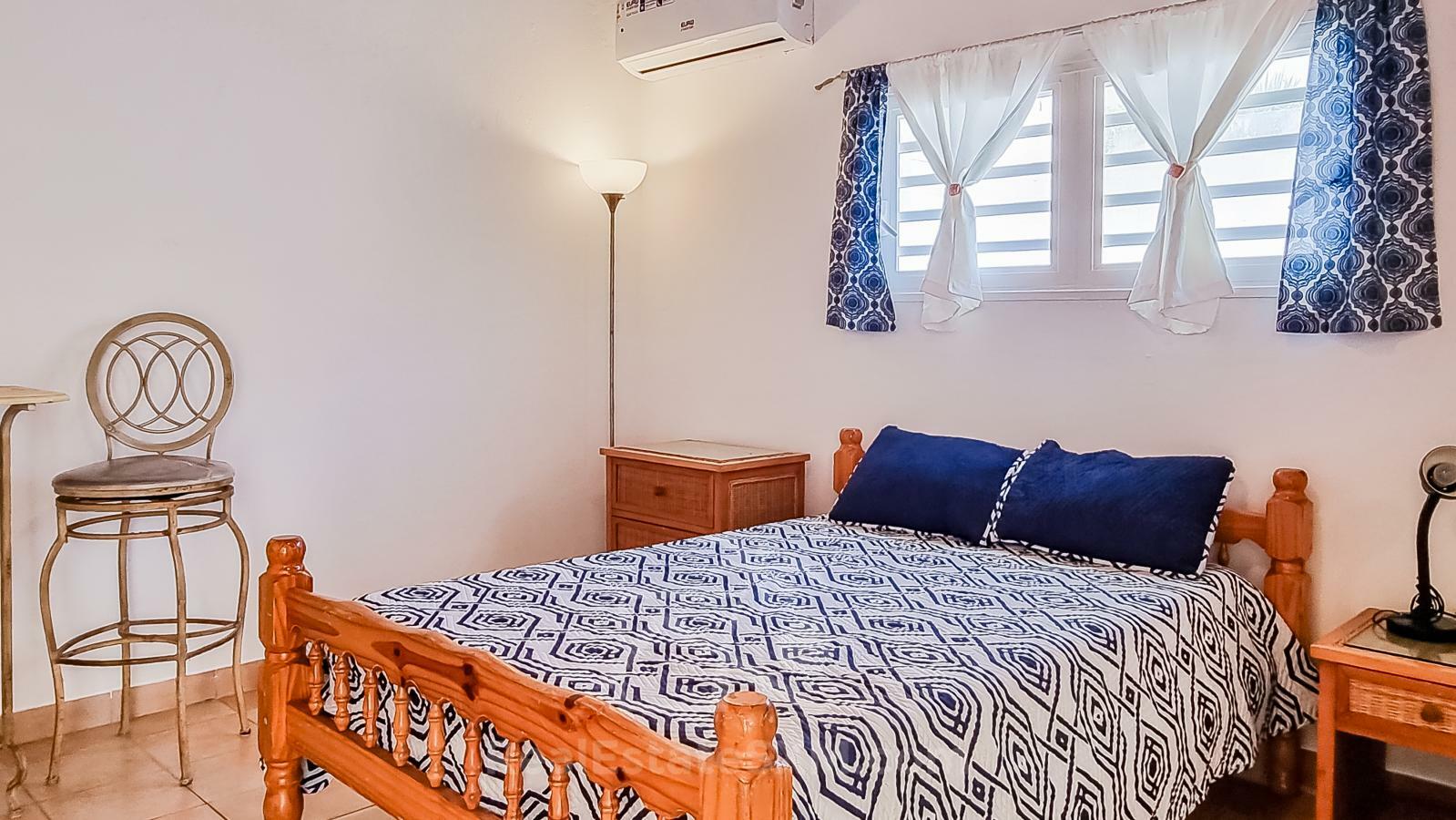 Waterfront Caribbean Villa for sale St Maarten, Beacon Hill. 2 bedrooms + Studio. Beach view. Boats