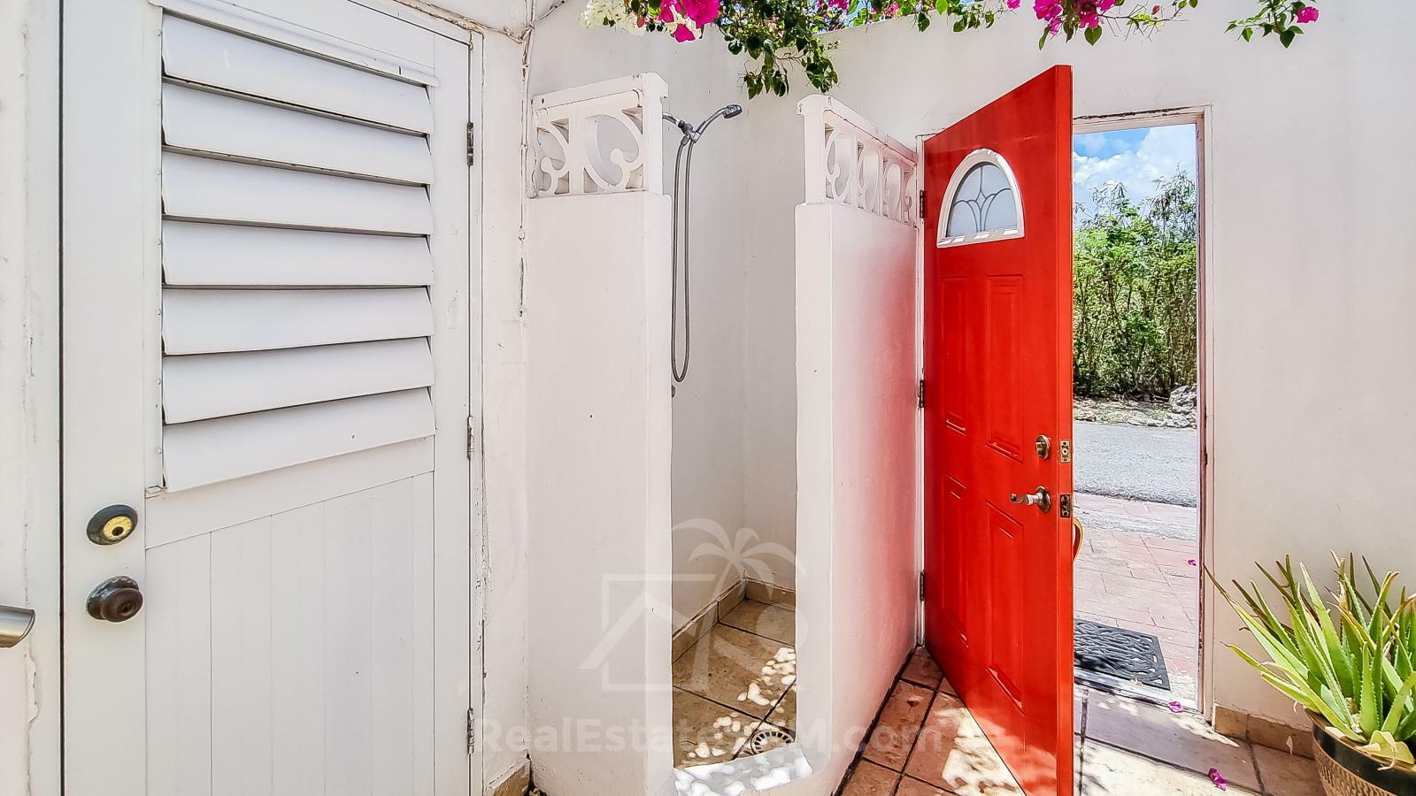 Waterfront Caribbean Villa for sale St Maarten, Beacon Hill. 2 bedrooms + Studio. Beach view. Boats