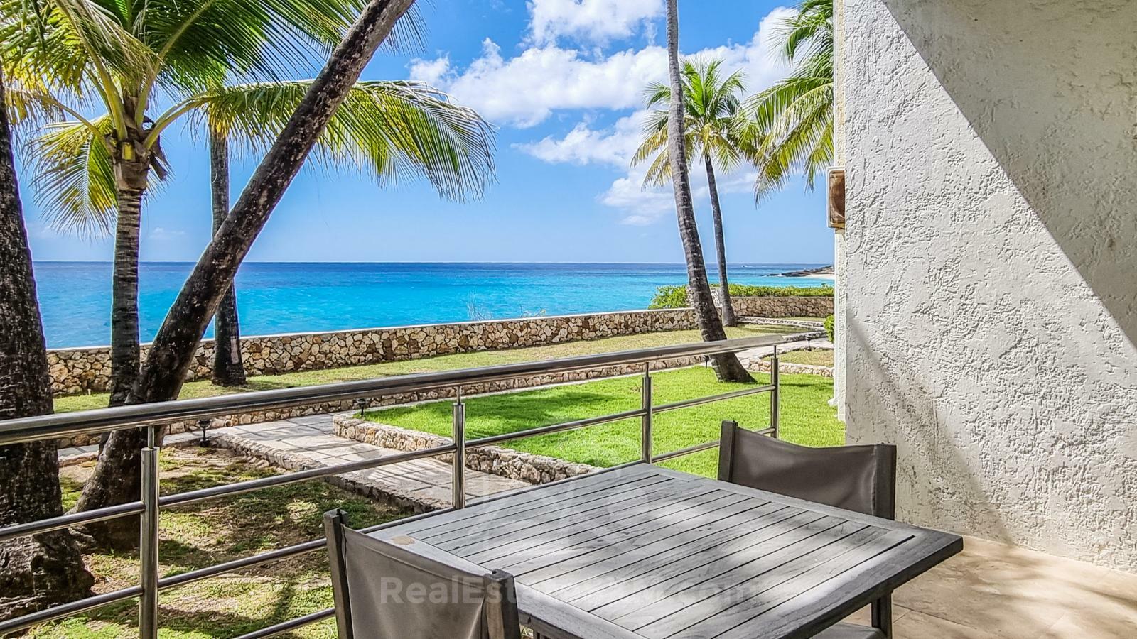 Waterfront condo in St Maarten Cupecoy Beach Club For Sale. Caribbean Sunsets. Private Beach. Gated